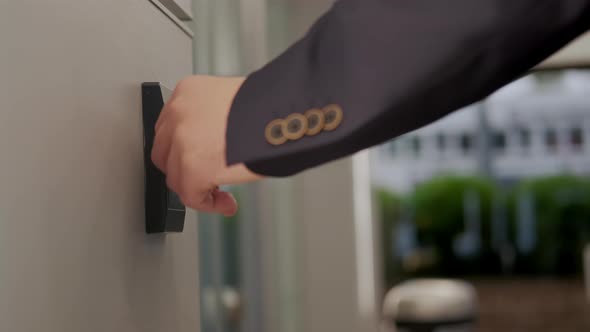 Man in Suit Opens the Door to Office Building Using a NFC Key Card alt
