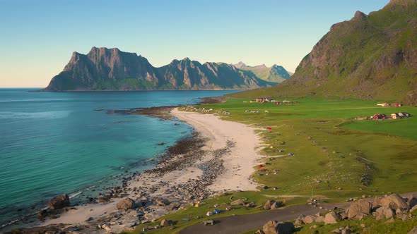 Pan Left of Uttakleiv Beach with Camping Tourists and Tents in Lofoten Norway alt