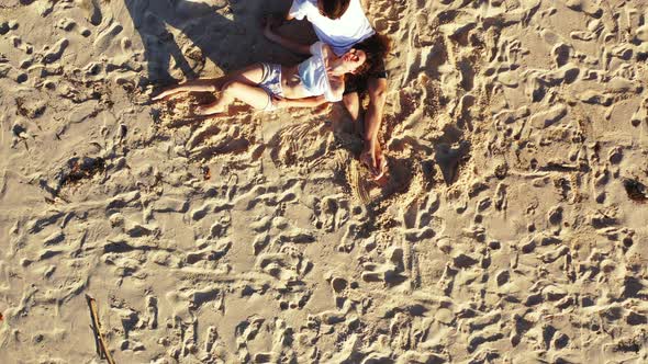 Fun boy and girl on honeymoon vacation have fun on beach on paradise white sand background  alt