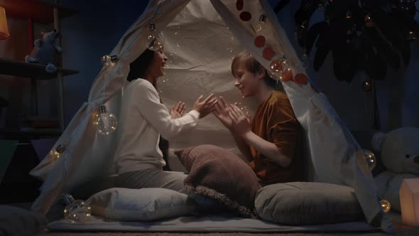 Young Boy and Girl Playing Clapping Game While Spending Free Time in Evening alt