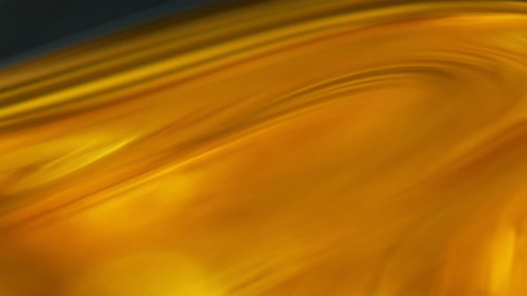 Super Slow Motion Shot of Moving Oil Waves Isolated on Black Background at 1000Fps alt