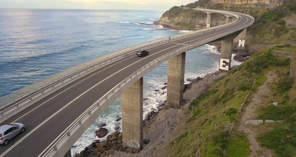 Cars Driving Along Sea Cliff Bridge
