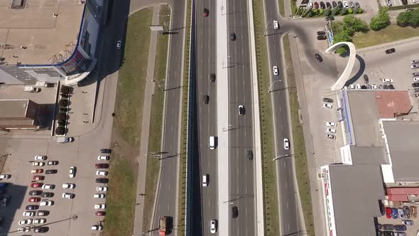 Car Traffic on Road and Parking Area in City, Moving Aerial View