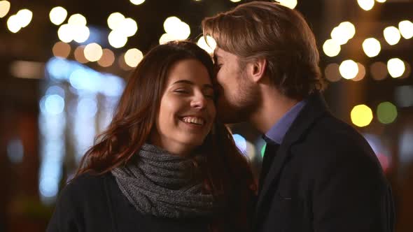 Two Young Caucasian Beautiful Lovers Standing Outdoors Gently Touching Each Other Kissing in alt