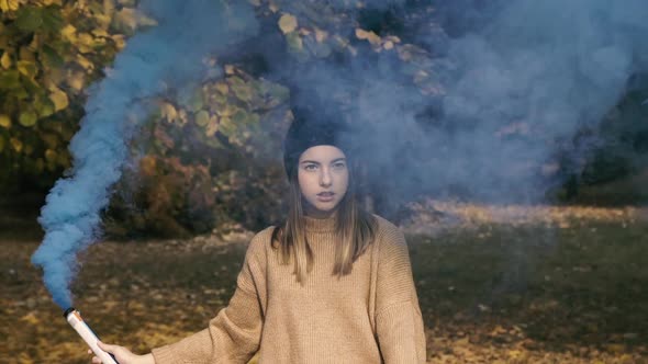 Portrait of Smart Girl Poses in Park and Using Colourful Fires alt