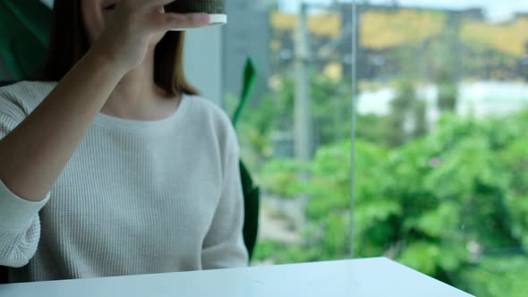 Closeup of a couple people clinking and drinking coffee together