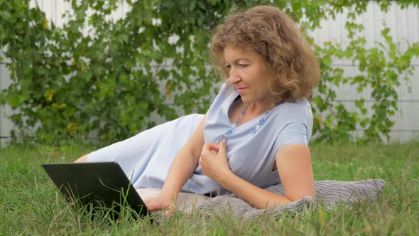 Lady with notebook working outdoor. Office outdoor. Working with notebook on fresh air