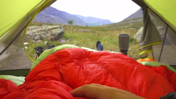 Feet Man Relaxing Enjoying Mountains with Cup of Tea From Tent Entrance Outdoor