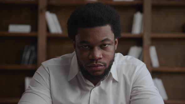 Young Adult African American Businessman Raising His Head Up and Looking at Camera alt