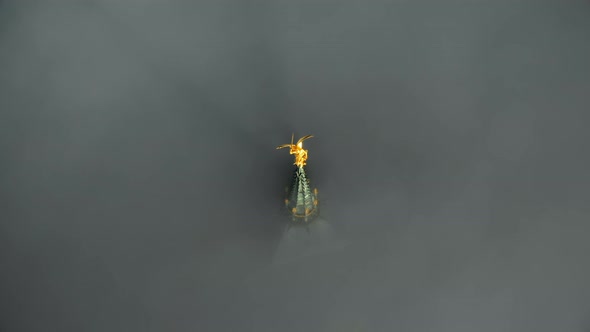 Epic Aerial Close-up Shot of Heavenly Golden Statue on Mont Saint Michel Castle Steeple Top Above alt