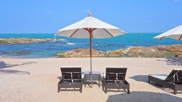 Tropical Holiday Concept, Sunbeds and Parasols on Beach With Horizon View alt