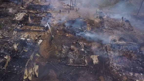 Aerial View of Burned Houses in Village, Firefighters Are Extinguishing Fire