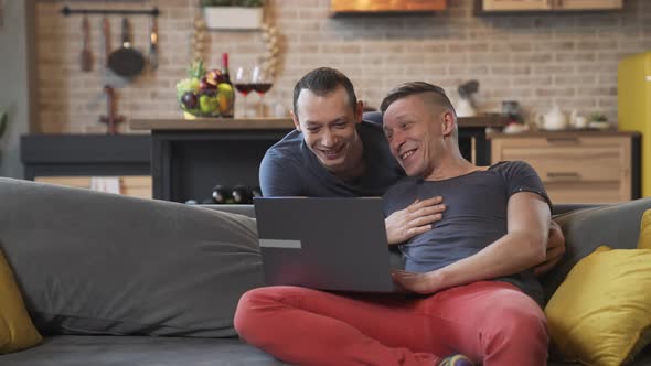 Cheerful Male Gay Couple Spends Time Together alt