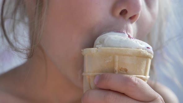 Small Girl Eats Icecream in Waffle Glass and Bites alt