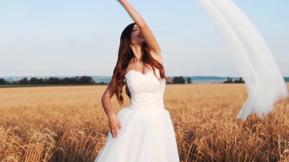 Bride In Wheat Field On Sunset