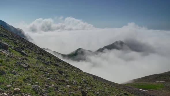 8K Treeless High Altitude Mountain Slope Above the Clouds