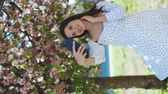 Smiling Woman in Summer White Dress Taking Selfie Self Portrait Photos on Smartphone