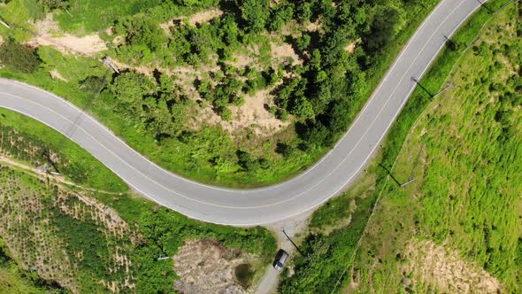 Aerial footage of sky road in spring season on tropical rainforest mountain in Nan province