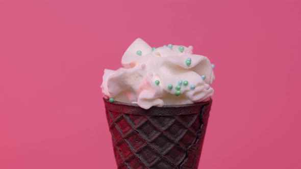 Soft Ice Cream in Black Cone Decorated with Colorful Sprinkles