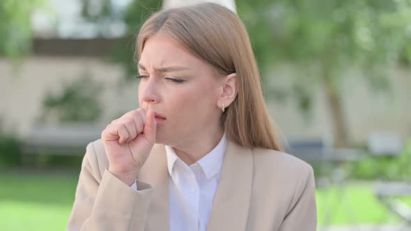 Outdoor Portrait of Young Businesswoman Coughing alt
