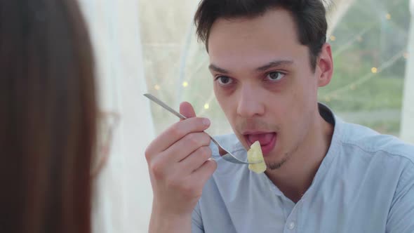 A Young Guy Eats Pineapple