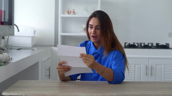 Happy Attractive Young Woman Reading Pleasant News in Letter Postal Correspondence Feeling Excited alt
