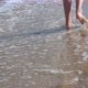 Child Feet on Sand Beach