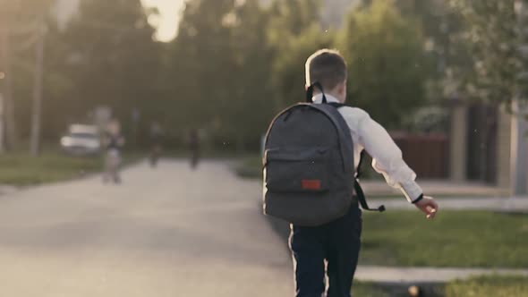 CU Tracking Slow Motion Back View Shot Student After School Hours Runnning Home alt