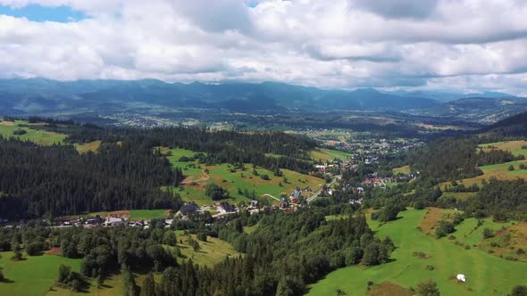Flight Over a Mountain Cottage Village in Poland, Zakopany, Tatra National Park Aerial 4K Video alt