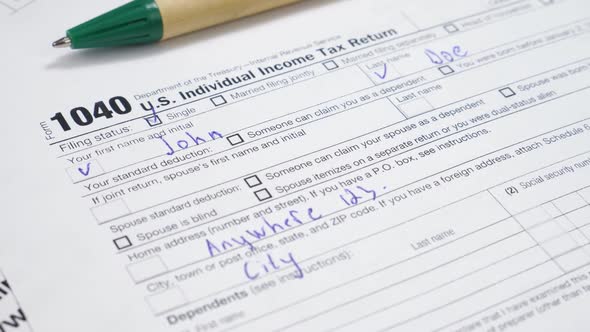 IRS 1040 U.S. Tax Form and Green Pen