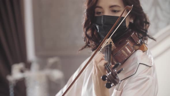 Beautiful Girl in Mask Playing the Violin