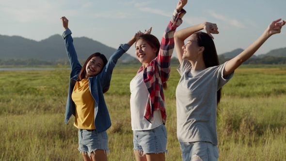 Group of a young Asian woman holding hands walking having fun together a summer traveling.