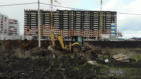 Work excavator at a construction site. alt
