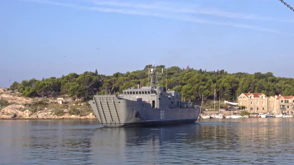 A Warship Leaves the Port in the Morning
