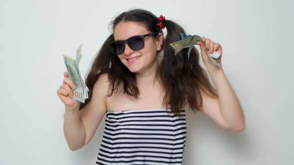 A Funny Woman Dances Holding a Lot of Money in Her Hands Throws Money Up alt