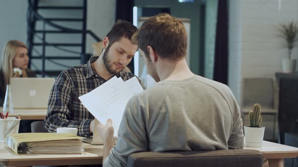 Men Are Sitting at Table in Modern Offce and Shaking Hands, Making Agreement alt