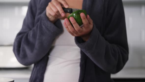 Woman cooking in kitchen alt