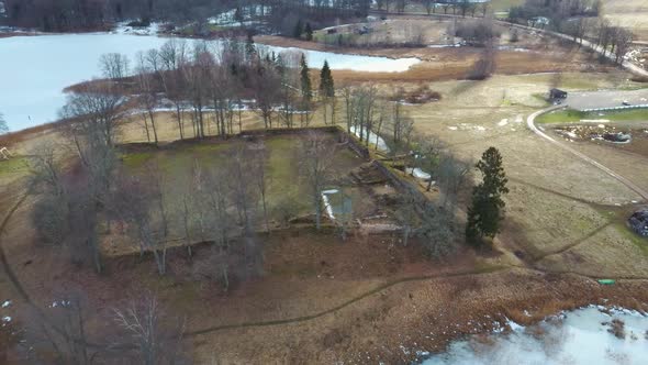 Araisi Lake Castle in Latvia Aerial Shot From Above. Historical Wooden Buildings on Small Island in alt