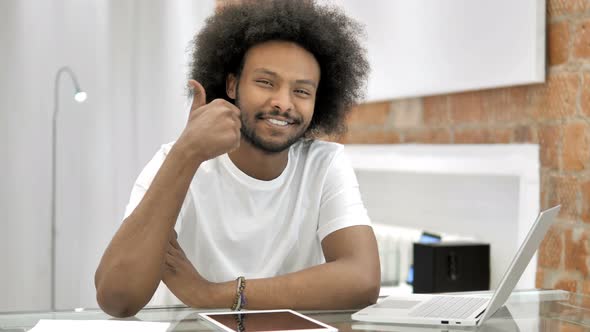 Thumbs Up By African Man Looking at Camera alt