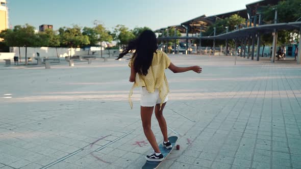 Pretty Athletic Girl Rides A Longboard In Modern City Stock Footage