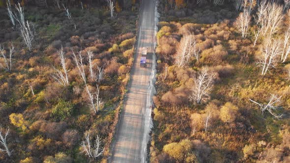 Aerial View of Truck on the Road in Beautiful Autumn Altai Forest