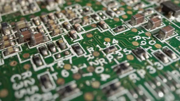 Extreme close-up of green Printed Circuit Board Electronics shot with dolly alt