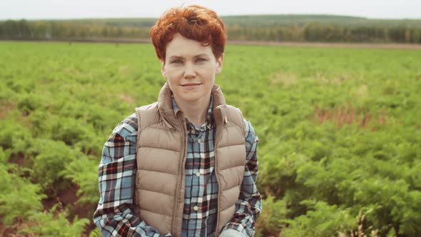 Portrait of Young Redhead Woman on Farm Field alt