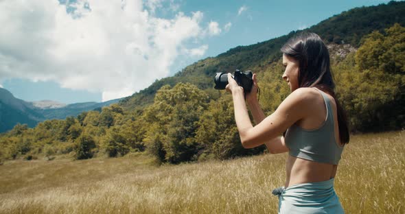 Inspired Attractive Woman Shoot Photo on Journey to Mountain Standing on Meadow alt