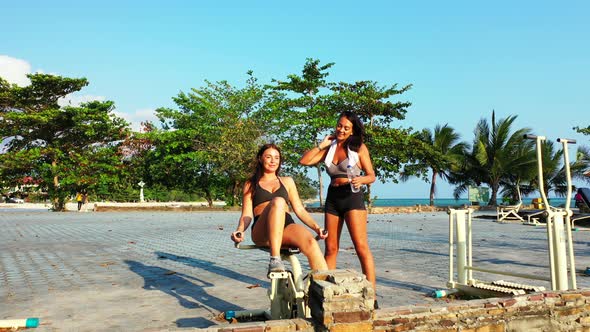 Sexy beauty models travelling spending quality time at the beach on clean white sand  alt