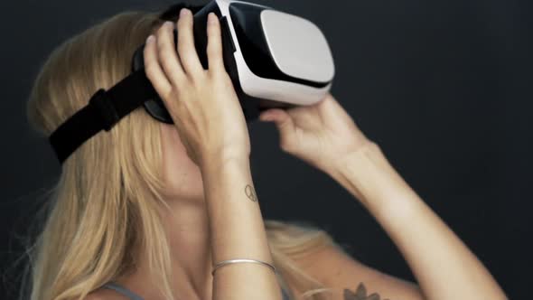 Woman using virtual reality simulator alt
