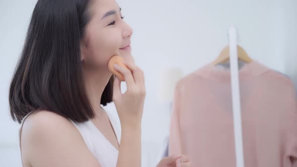 Beauty blogger present beauty cosmetics sitting in front camera for recording video. alt