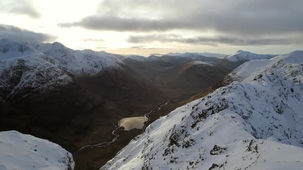 Mountaineer on the Summit of a Snowy Mountain alt