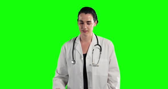 a Caucasian woman wearing surgeon blouse and scrumbs in a green background