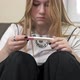 Teenage Girl Looks at the Result of a Pregnancy Test and Cries - VideoHive Item for Sale